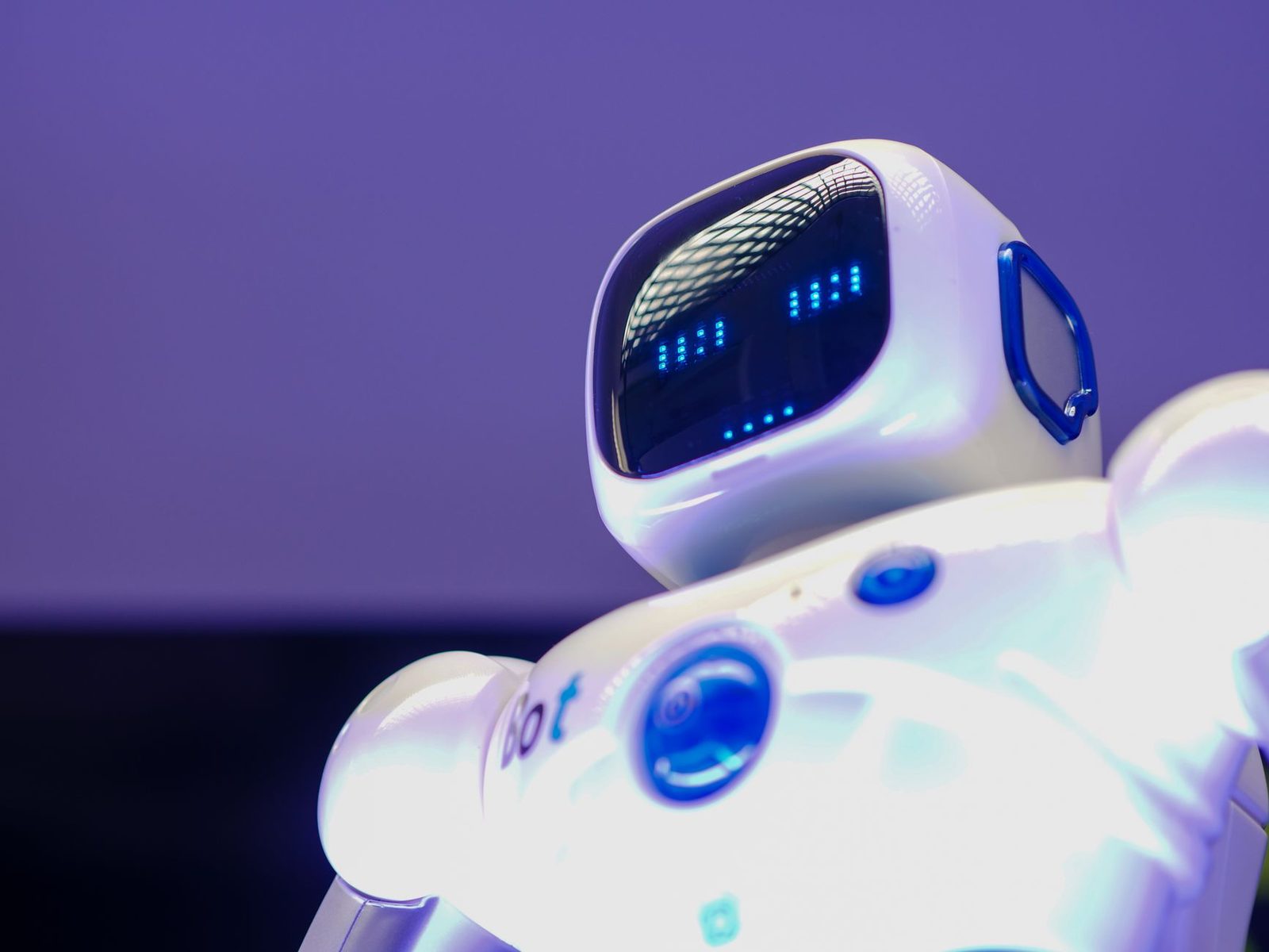A futuristic humanoid robot in an indoor Tokyo setting, showcasing modern technology.